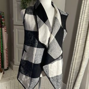 Flannel, black and white check sleeveless vest.